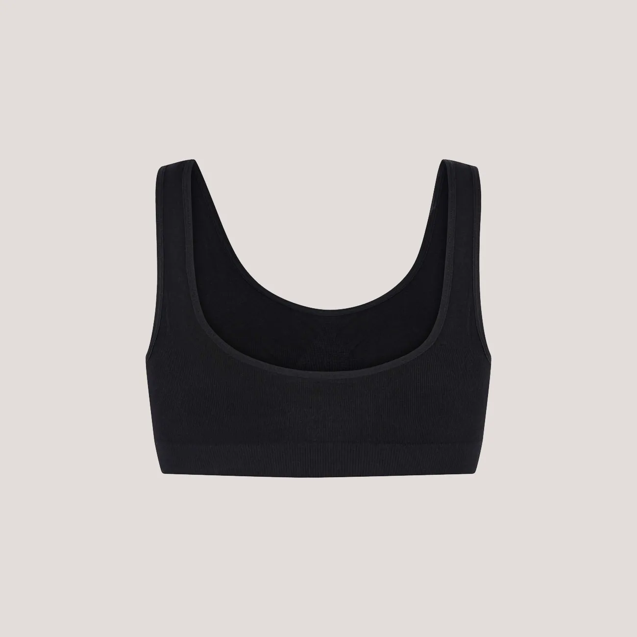 Input flat lay — black seamless scoop-neck bralette back view on neutral background, used as MODA AI source image