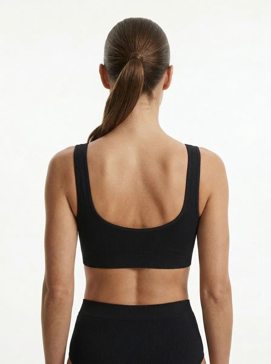 MODA AI output — back view of model in black bralette, showing strap placement, scoop back, and clean catalog framing