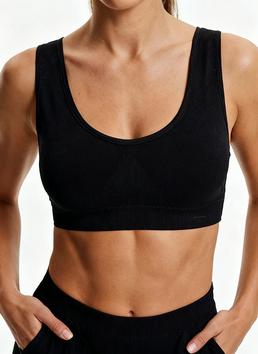 MODA AI output — close-up of black bralette on model, showing preserved scoop neckline, rib-knit band detail, and natural skin texture across torso